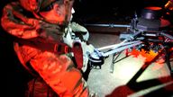 A marine prepares a bomber drone for flight