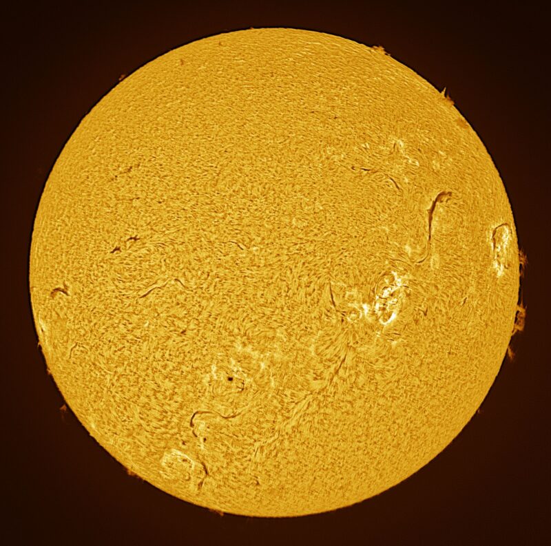 The sun, seen as a large yellow sphere with a mottled surface.