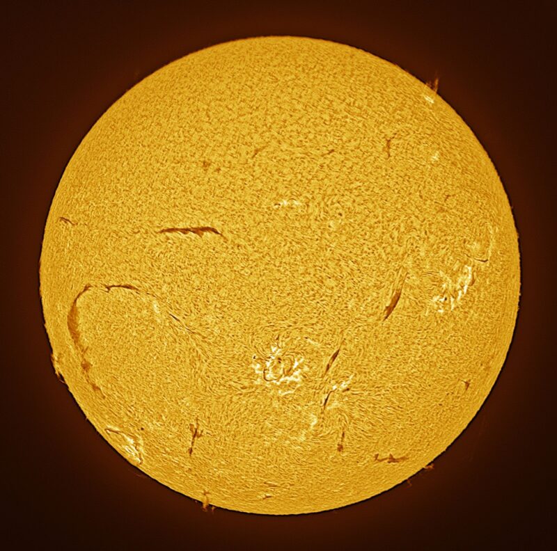 The sun, seen as a large yellow sphere with a mottled surface.