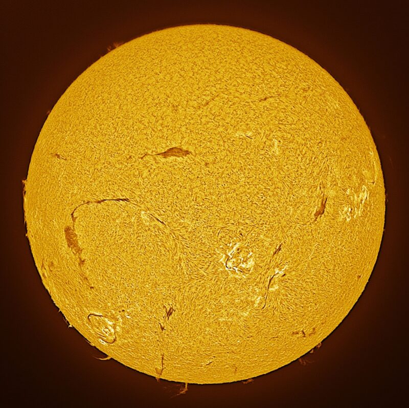 The sun, seen as a large yellow sphere with a mottled surface.