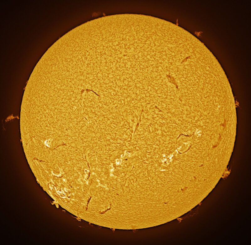 The sun, seen as a large yellow sphere with a mottled surface.