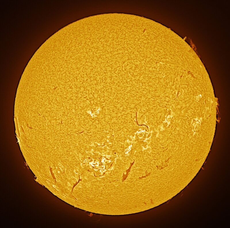 The sun, seen as a large yellow sphere with a mottled surface.