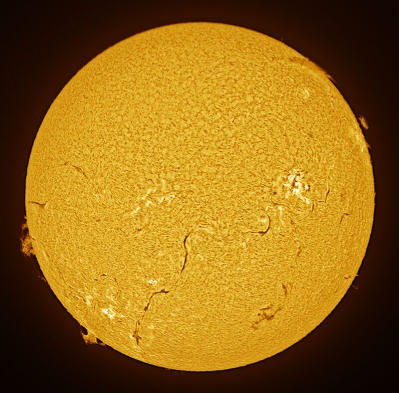 The sun, seen as a large yellow sphere with a mottled surface.