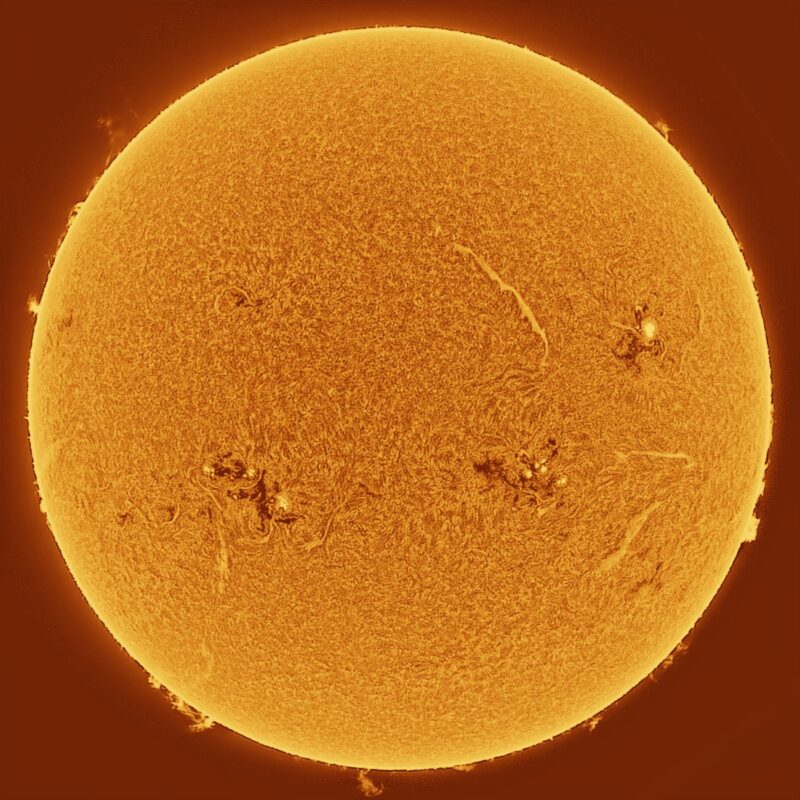 The sun, seen as a large yellow sphere with a mottled surface.