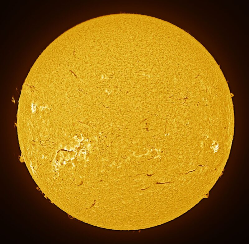 The sun, seen as a large yellow sphere with a mottled surface.