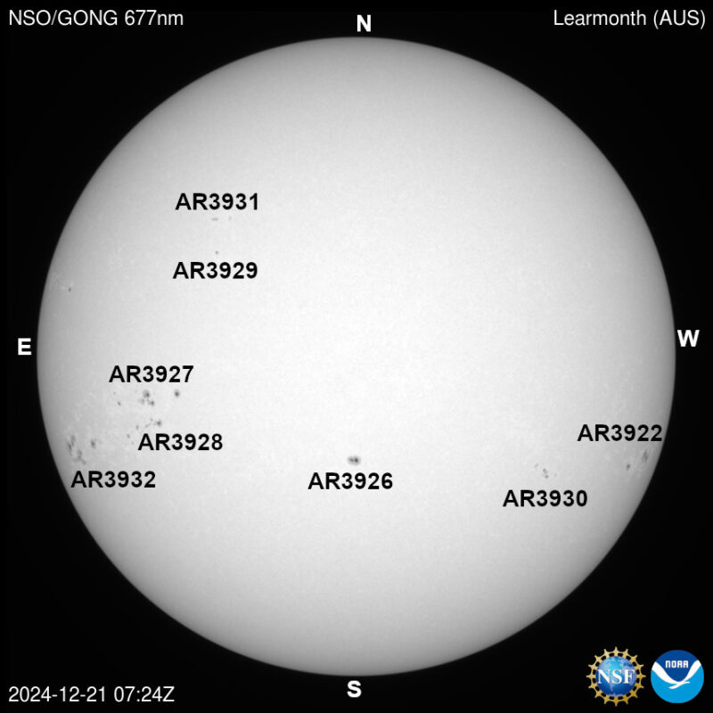 The sun, seen as a large white sphere with dark spots, each labeled.