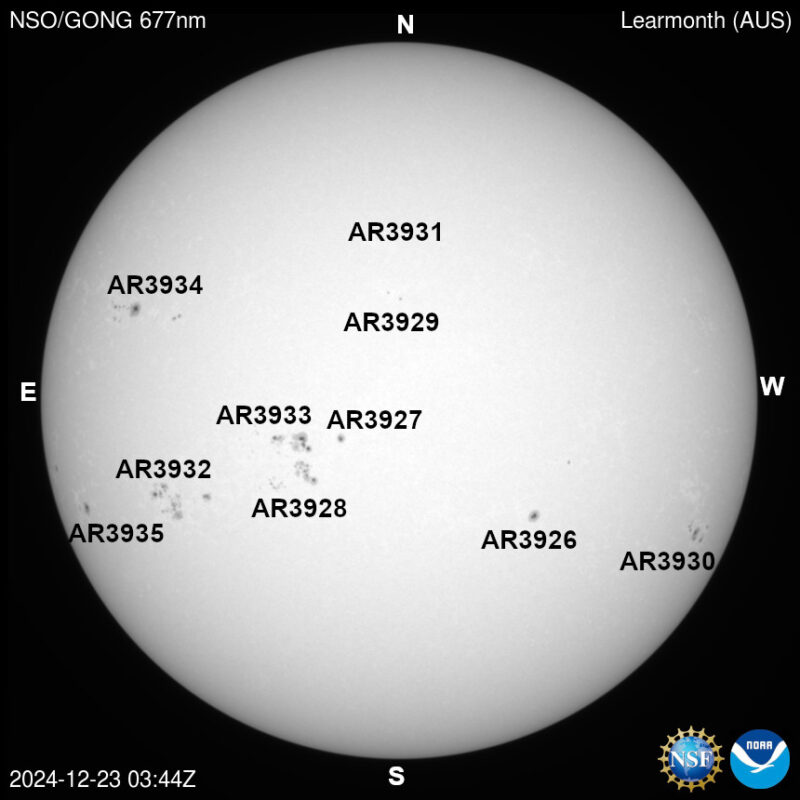 The sun, seen as a large white sphere with dark spots, each labeled.