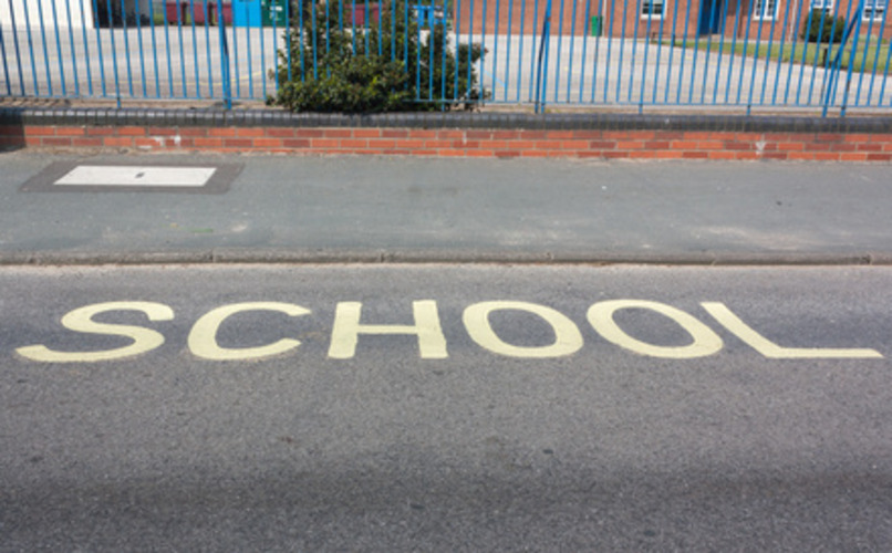 White school zone marking on a pavement