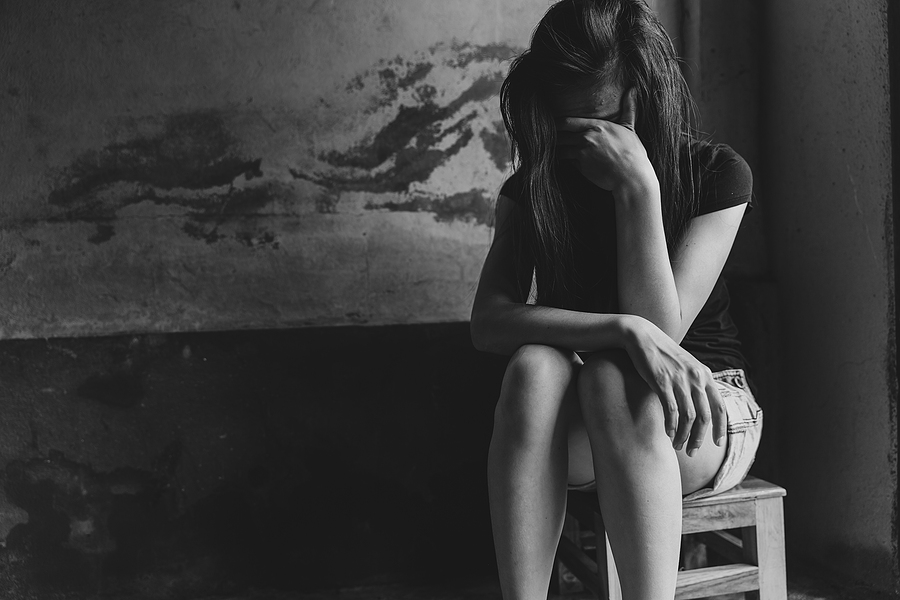 A depressed woman sitting on a chair