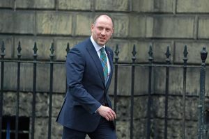 Neil Gray wearing a suit and arriving at Bute House, Edinburgh.