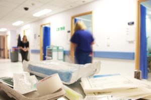 Busy NHS hospital with blurred movement from nurses and doctors