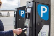 Stock image of a woman using a parking charge machine