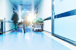 A busy hospital with patients being treated in the corridor