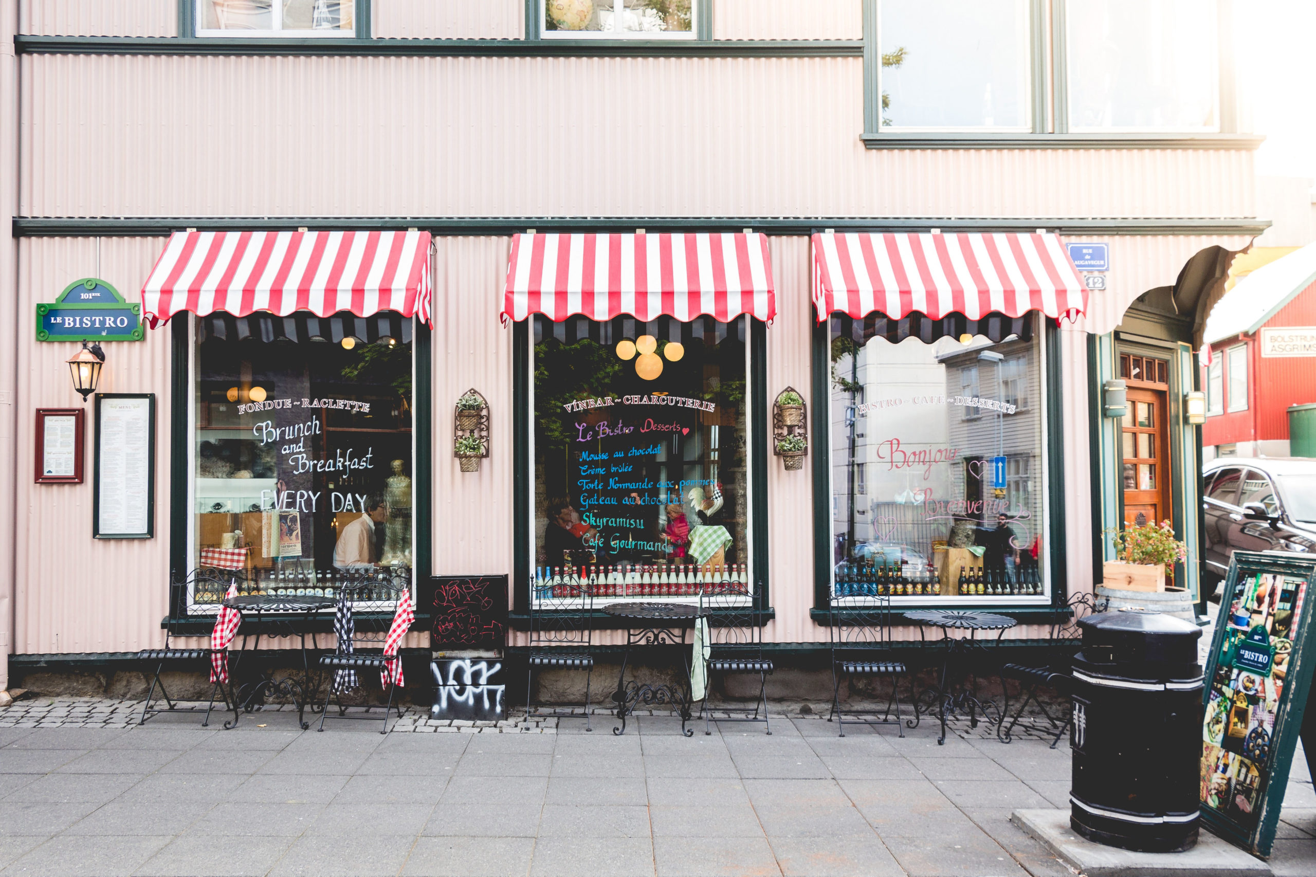 a small shop with red-and-white awnings over the windows