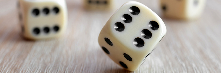 rolling dice on a wooden desk