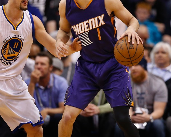 PHOENIX, AZ - FEBRUARY 10:  Devin Booker #1 of the Phoenix Suns handles the ball during the NBA game against the Golden State Warriors at Talking Stick Resort Arena on February 10, 2016 in Phoenix, Arizona.  The Warriors defeated the Suns 112-104. NOTE TO USER: User expressly acknowledges and agrees that, by downloading and or using this photograph, User is consenting to the terms and conditions of the Getty Images License Agreement.  (Photo by Christian Petersen/Getty Images)