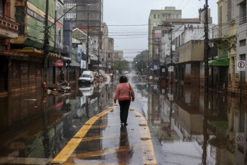 A woman walks through a flooded street in Porto Alegre, Brazil, on May 24.