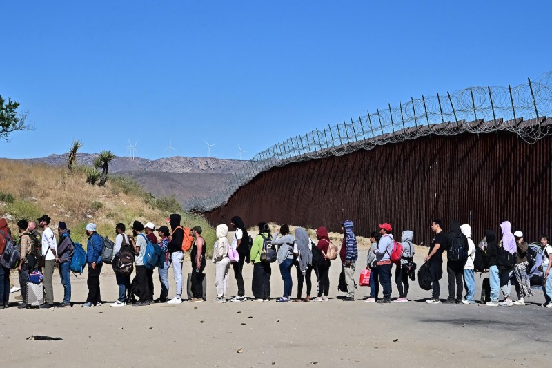 Migrants wait in line for processing from U.S. border agents after arriving at Jacumba Hot Springs, California, on June 5.