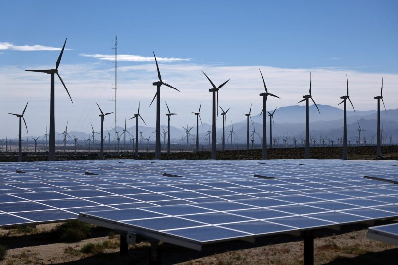 Wind turbines operate at a wind farm near solar panels near Palm Springs.