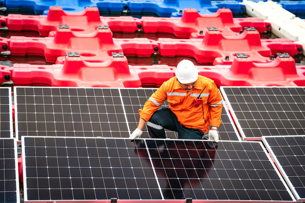 engineer working on installing floating solar panels on buyos