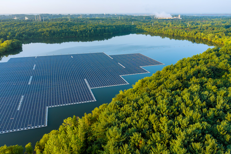 floating solar panel farm in the middle of a lake