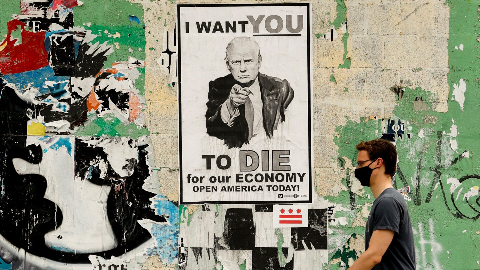 A man walks past a poster depicting President Donald Trump in the Shaw neighborhood of Washington on May 25, 2020.