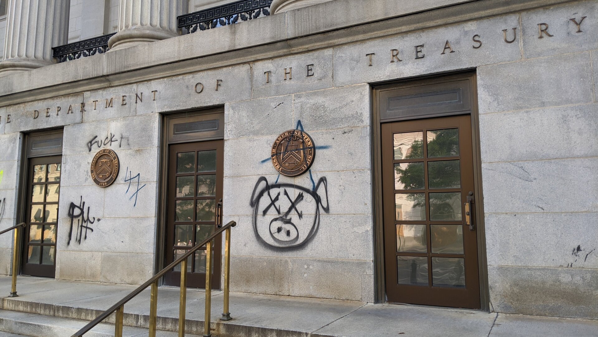 Pig graffiti on the entrance of the U.S. Treasury Department, June 2.