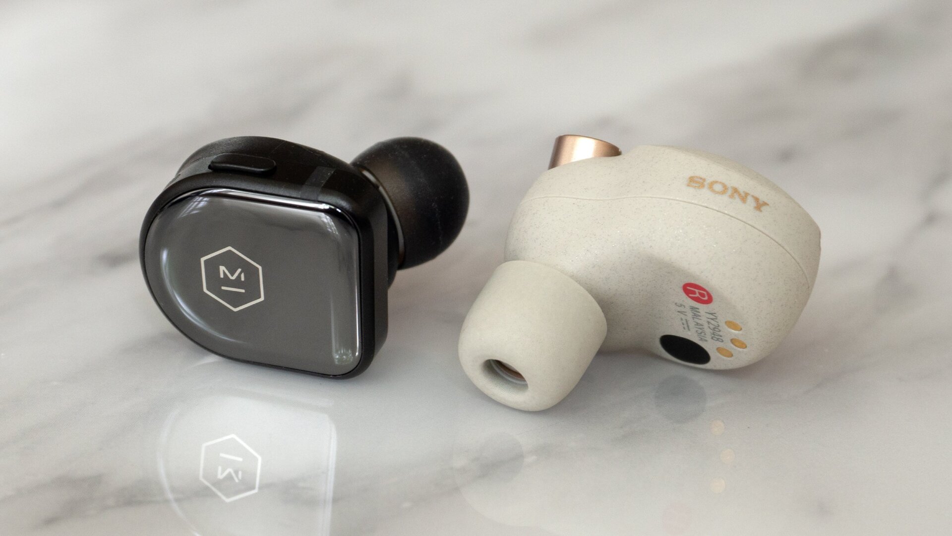 Despite being smaller, the Master & Dynamic MW08 wireless earbuds (left) include 11mm drivers, compared to the 6mm drivers in the larger Sony WF-1000XM3 earbuds (right).