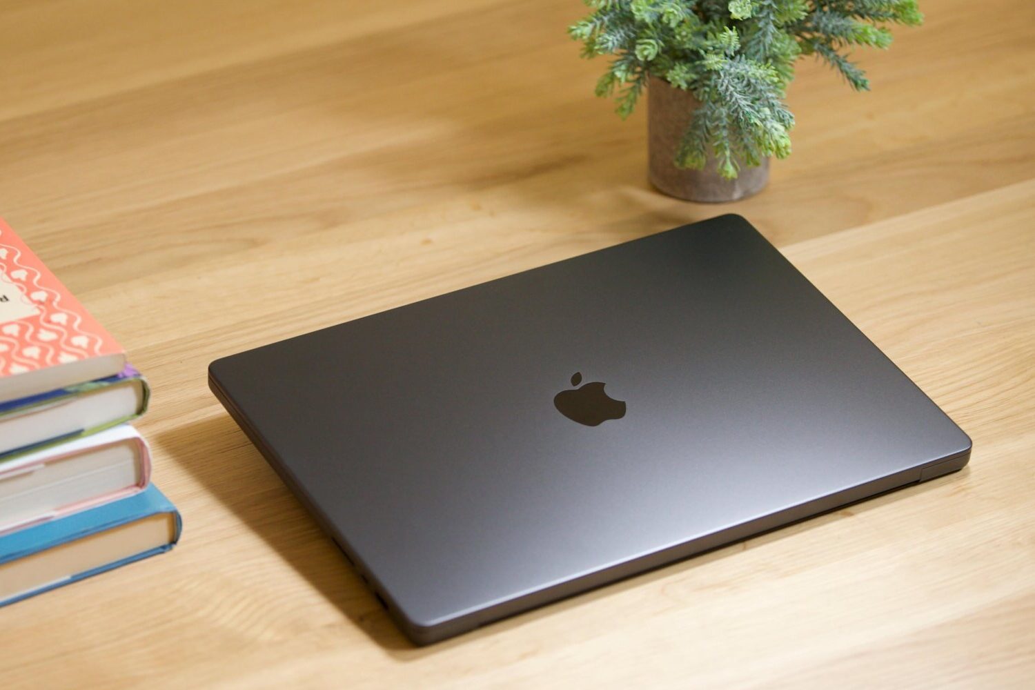 An M3 MacBook Pro sitting next to books