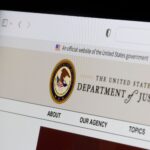 A computer showing the website fo the U.S. Department of Justice.