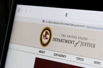 A computer showing the website fo the U.S. Department of Justice.