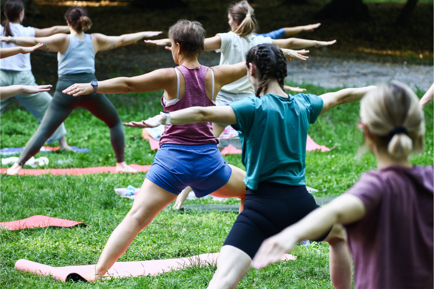 People attending an outdoor yoga class.