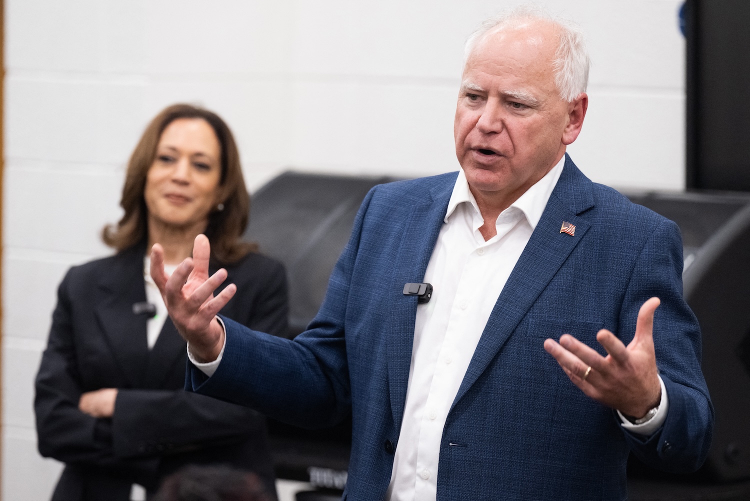 Kamala Harris listens to Tim Walz speak during a visit with members of the marching band at Liberty County High School in Hinesville, Georgia, August 28, 2024.