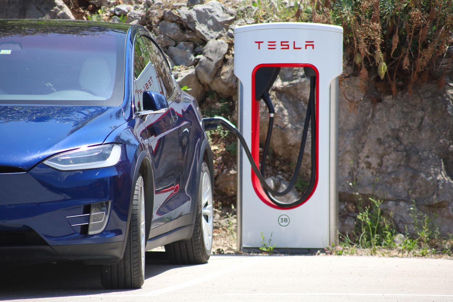 A Blue Tesla at a Charging Station