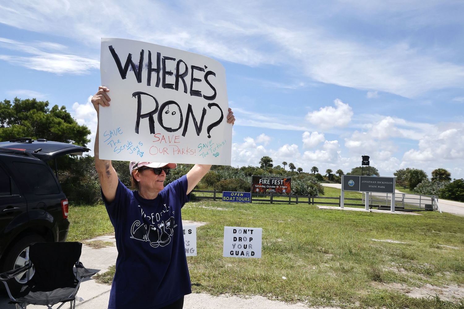 Kathy Moore of Jupiter, Florida, protests in front of Jonathan Dickinson State Park in Hobe Sound on Tuesday, Aug. 27, 2024.