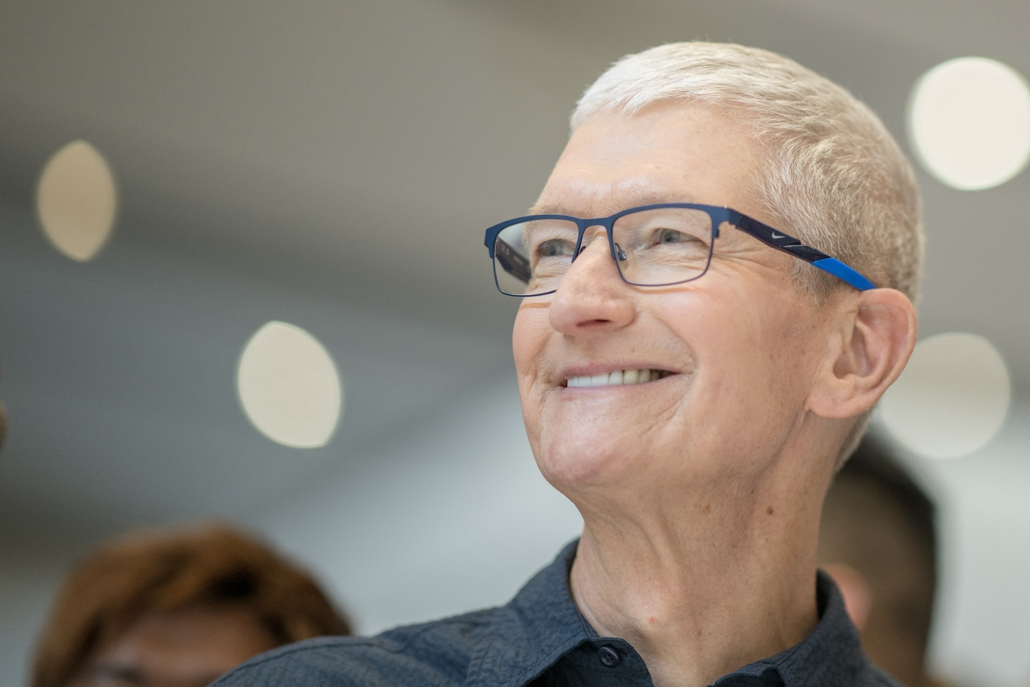 Apple CEO Tim Cook looks at new iPhone models following Apple's "It's Glowtime" event in Cupertino, California, September 9, 2024.