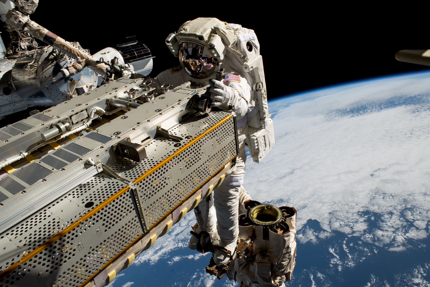 NASA astronaut and Expedition 68 Flight Engineer Woody Hoburg rides the Canadarm2 robotic arm while maneuvering a roll-out solar array toward the International Space Station’s truss structure 257 miles above the Pacific Ocean