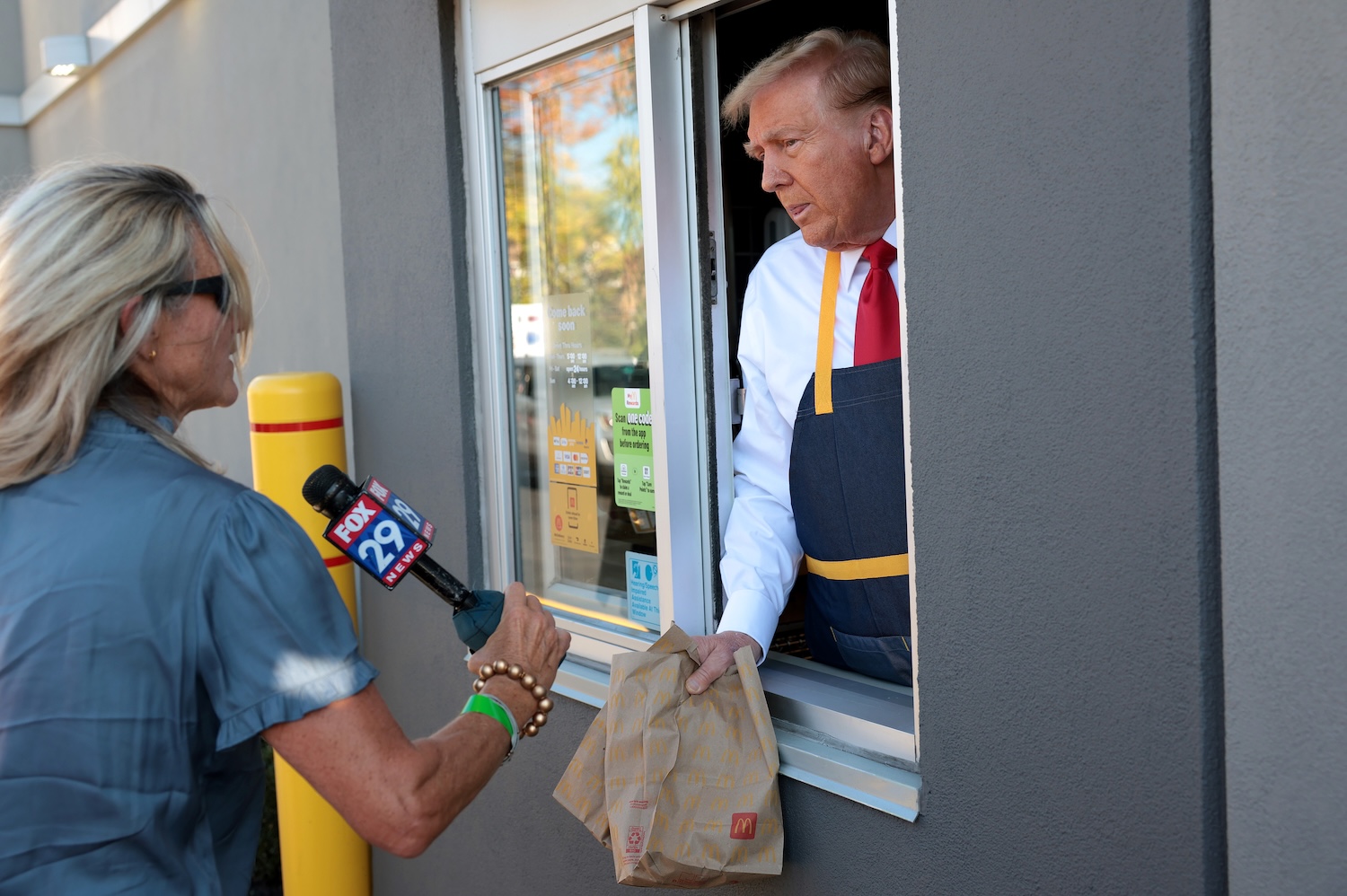 Donald Trump, convicted felon and traitor to the United States, poses with local media during a photo-op at a closed down McDonald's in Pennsylvania on Oct. 20, 2024.