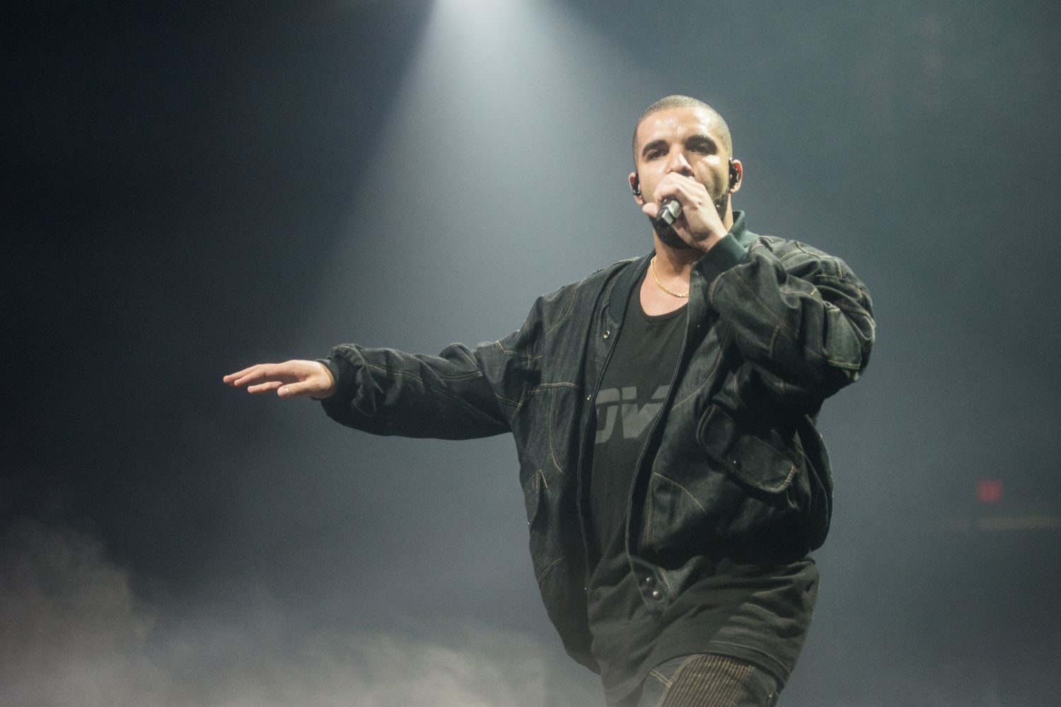 Drake performing on stage wearing all black