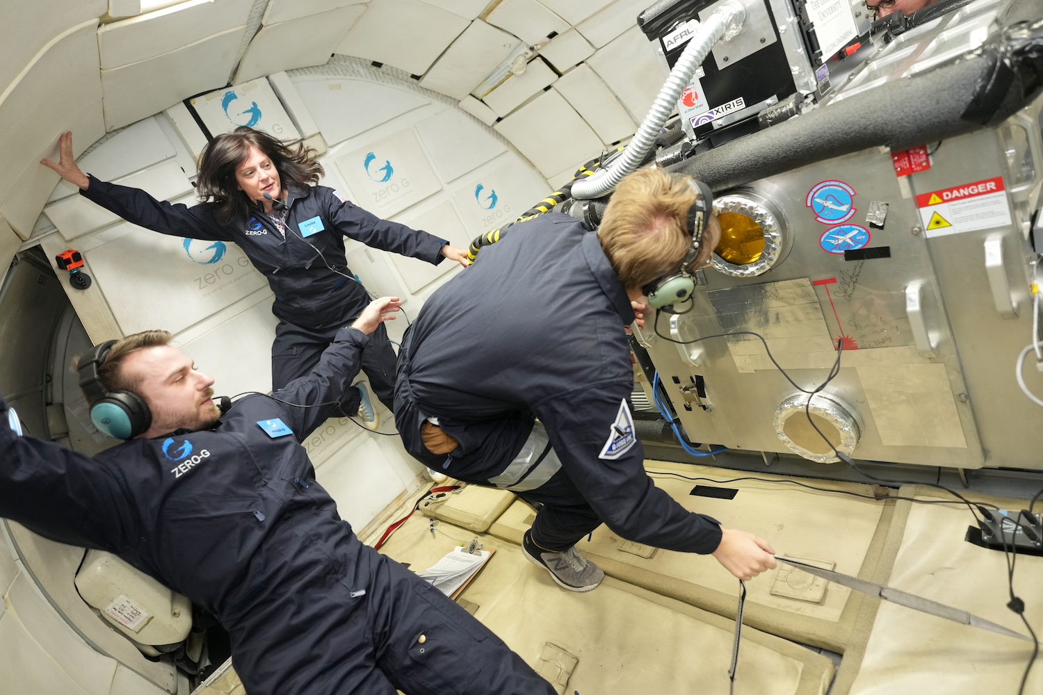 NASA Marshall engineers and scientists, along with their collaborators from Ohio State University, monitor laser beam welding in a vacuum chamber during a Boeing 727 parabolic flight