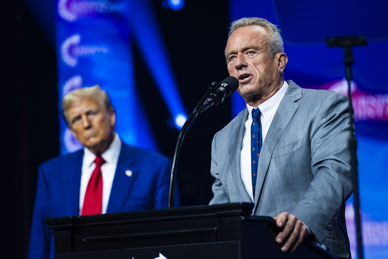 Robert F. Kennedy Jr. speaks with President Donald Trump at a Turning Point Action Rally in Duluth, GA on Wednesday, Oct. 23, 2024.