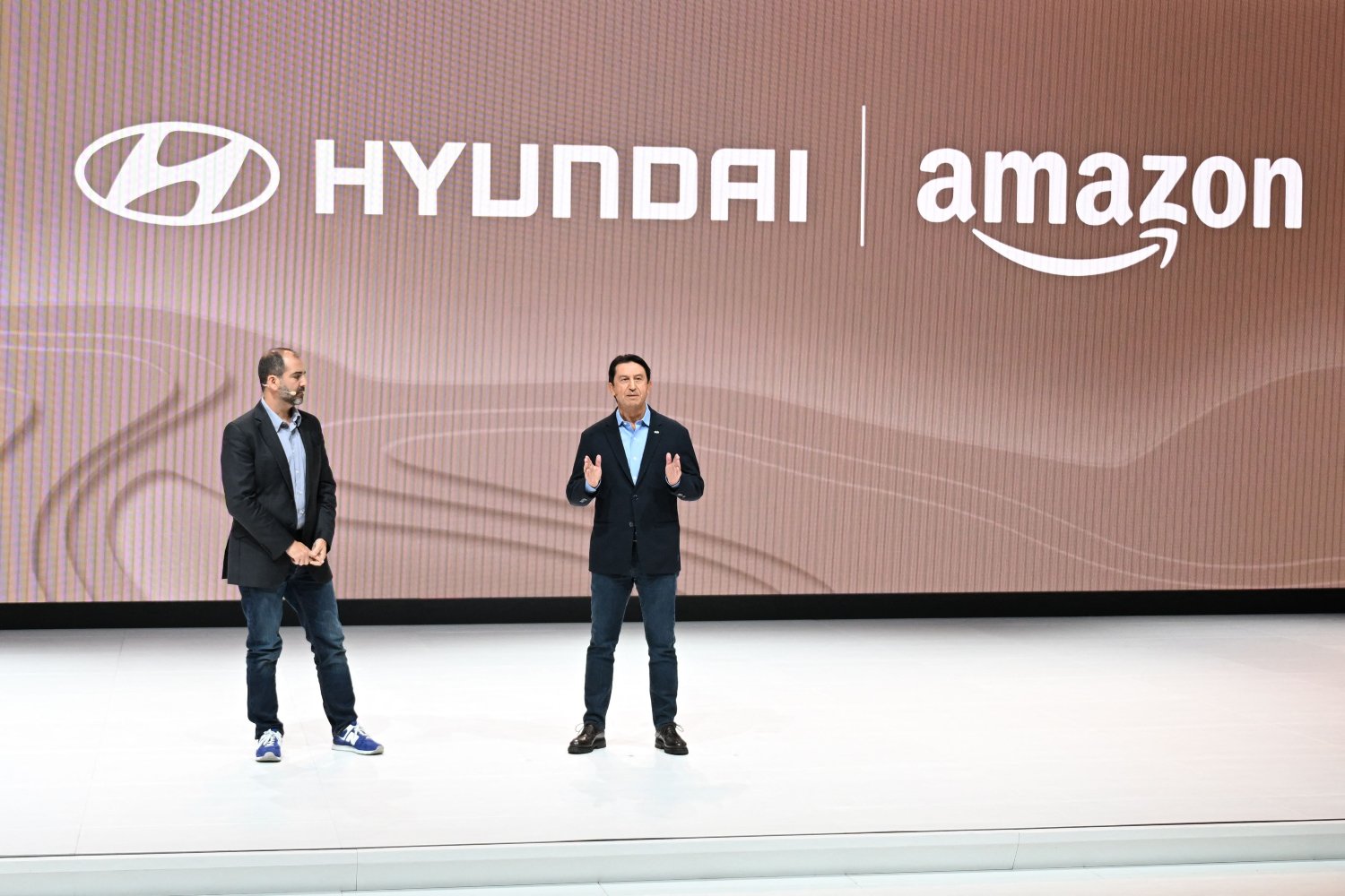 Amazon Vice President of Worldwide Corporate Business Development Marty Mallick (L) and Hyundai Global President and Chief Operating Officer Jose Munoz speak at the Hyundai press conference at Automobility LA