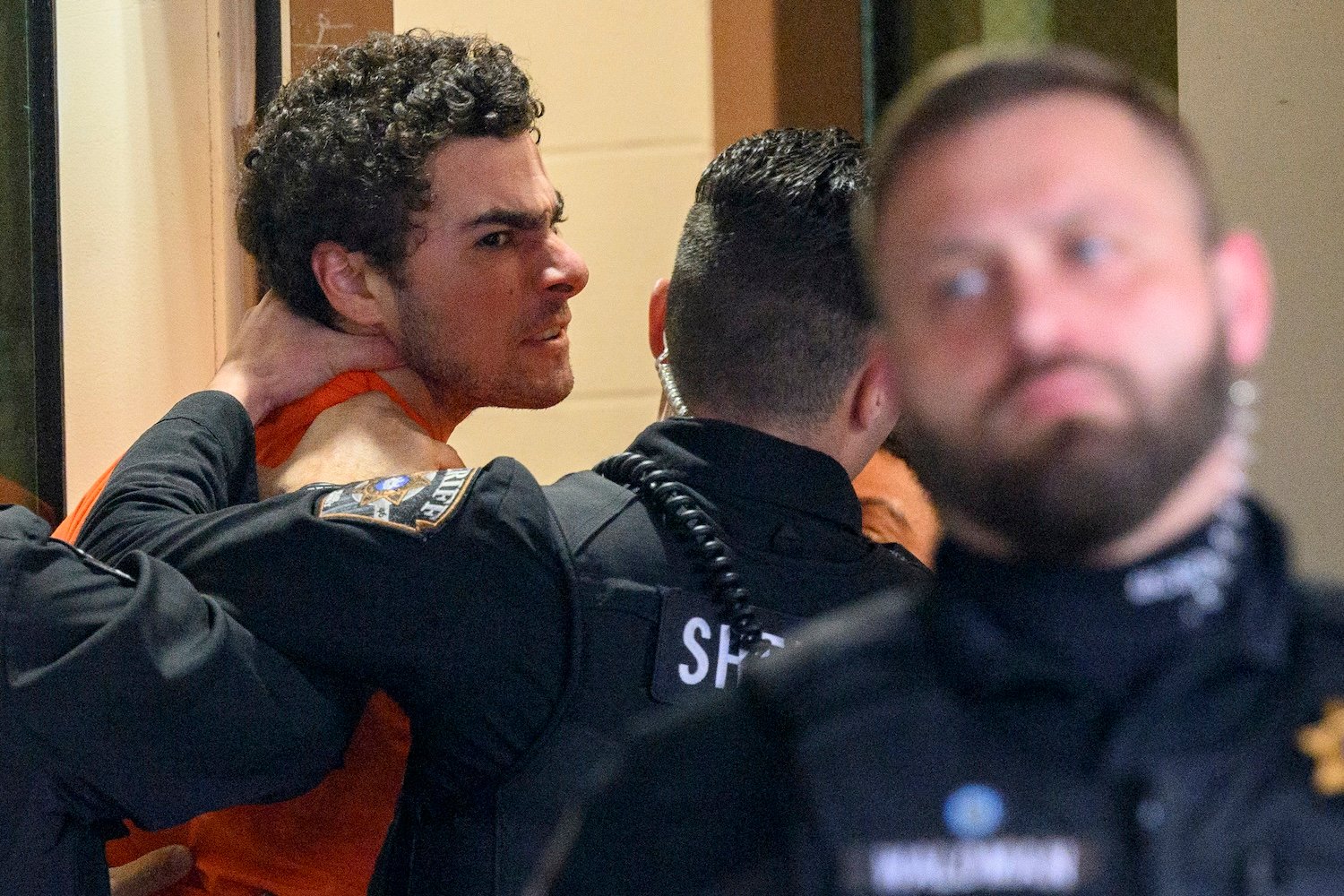 Suspected shooter Luigi Mangione is led into the Blair County Courthouse for an extradition hearing December 10, 2024 in Hollidaysburg, Pennsylvania.