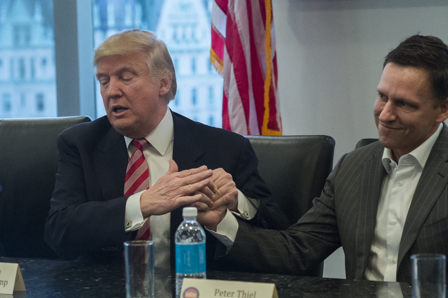 Donald Trump and Peter Thiel clasp hands