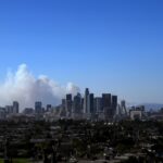 The city skyline is seen as the Palisades Fire burns amid a powerful windstorm on January 7, 2025 in Pacific Palisades, California.