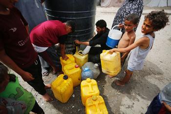 Children collect water in the Gaza Strip.