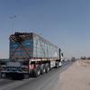 Trucks loaded with bottles of drinking water travel near El Arish, Egypt.