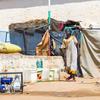 A woman collects water at an IDP camp in Darfur. The war in Sudan has forced millions to flee their homes.