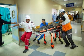 A man injured in a missile attack is rushed for treatment in Naser hospital in Khan Younis. 