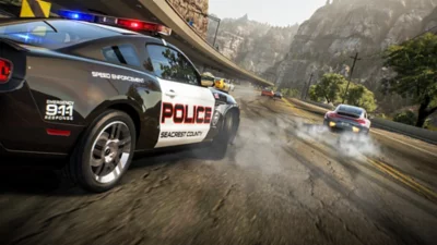 Need for Speed™ Hot Pursuit Remastered screenshot showing a police car chasing cars with mountains in the background.